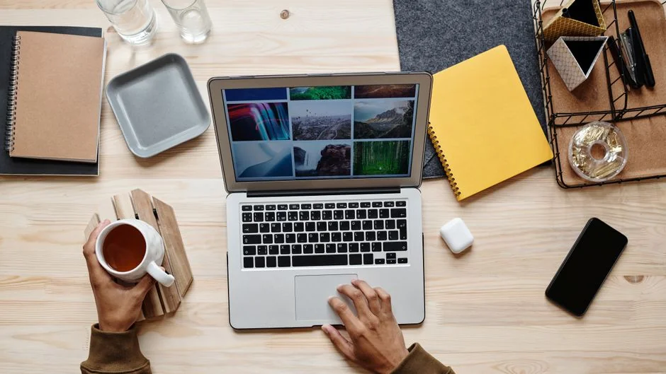 A modern workspace featuring dual computer monitors displaying web design projects, emphasizing technology and productivity.